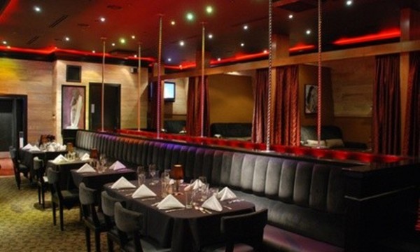 Six-Course Steakhouse Dinner and Risqué Cabaret Show for 2, 4, or 10 at CY Steak (Up to 49% Off)