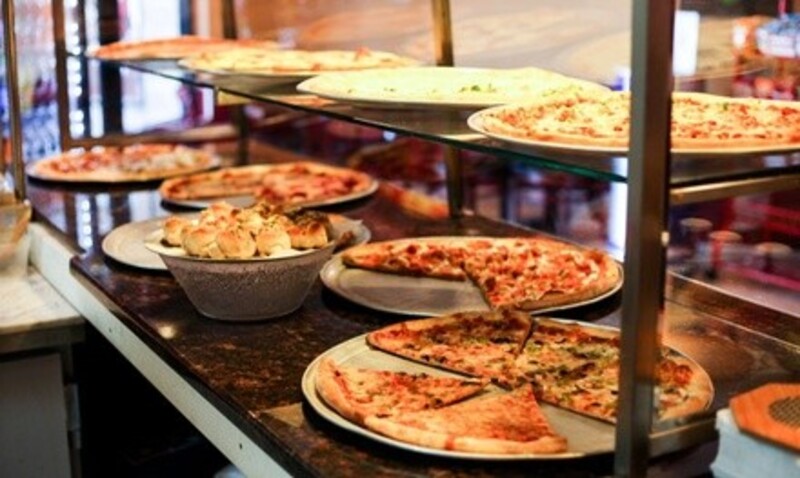 Cheese Pizzas, Wings, Subs, and More at Krispy Krust, Pick-Up and Dine-In if Available (Up to 25% Off)